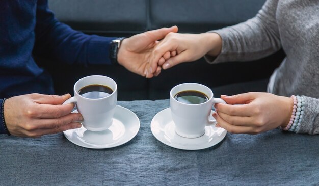 Uomo e donna al tavolo con una tazza di caffè