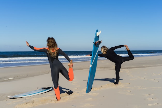 uomo e donna vanno all&#39;oceano con tavole da surf. l&#39;uomo e la ragazza vanno a fare surf