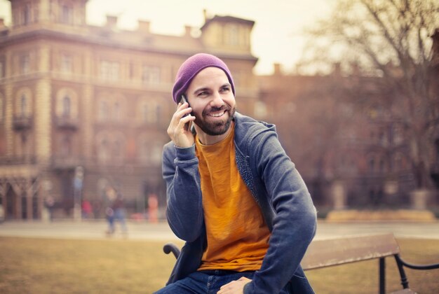 Uomo elegante che parla su uno smartphone