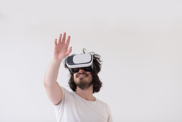 Uomo felice che ottiene esperienza utilizzando gli occhiali per cuffie VR della realtà virtuale, isolati su sfondo bianco