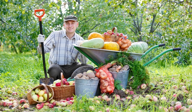 Uomo felice con un raccolto in giardino