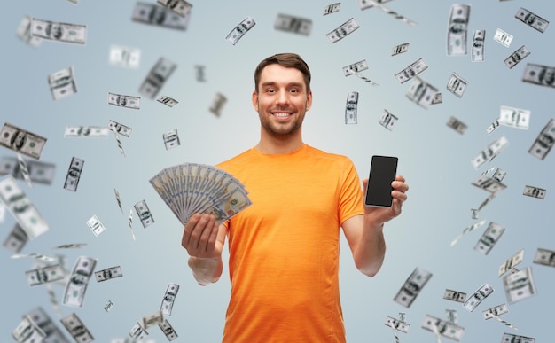 uomo felice con uno smartphone e dei soldi