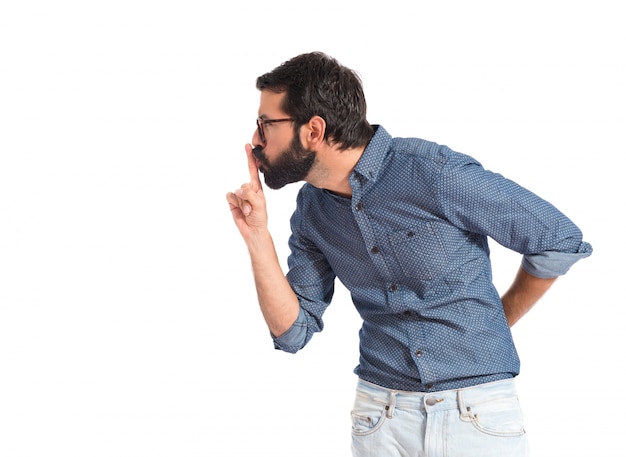 Uomo giovane hipster che fa gesto di silenzio