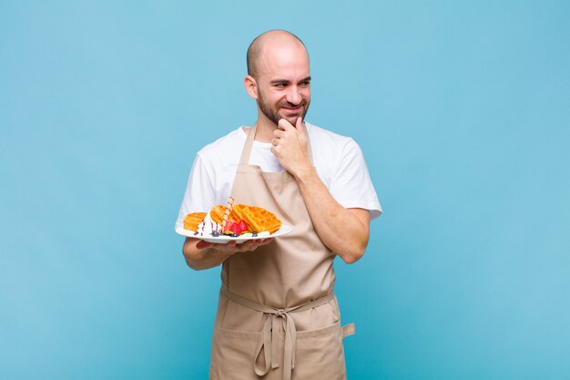 Uomo giovane panettiere con cialde