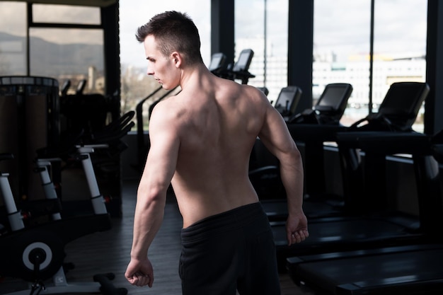 Uomo In Palestra Che Mostra Il Suo Corpo Ben Allenato