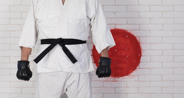 uomo in un kimono bianco karate con cintura nera