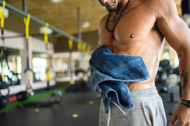 Uomo latino in una palestra che si asciuga con un asciugamano