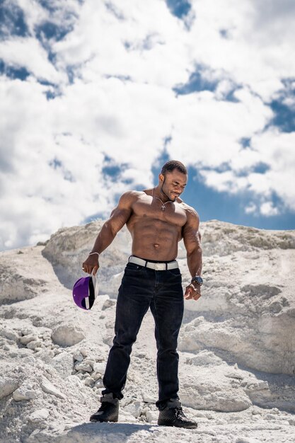 Uomo muscoloso che posa sulle montagne bianche Uomo muscolare che posa sulle montagne bianche