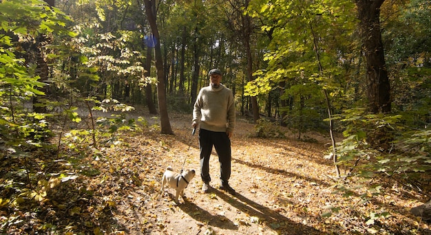 uomo nel parco cane carlino