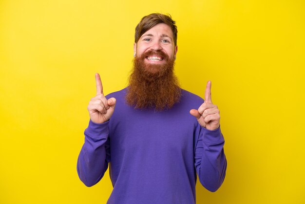 Uomo rosso con la barba isolato su sfondo giallo che indica una grande idea