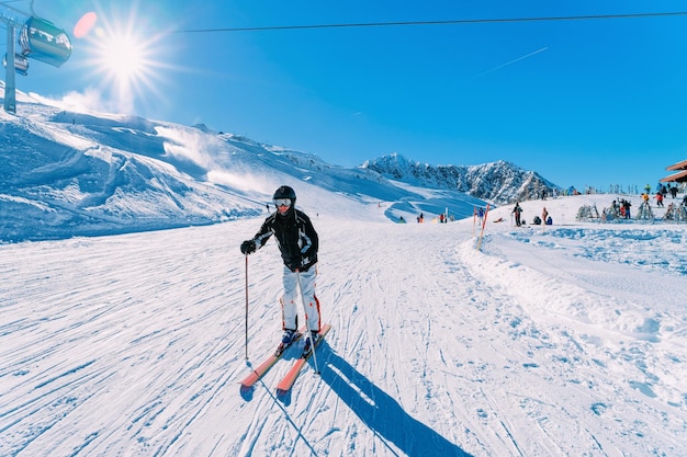 Uomo sciatore presso la stazione sciistica del ghiacciaio di Hintertux, Zillertal in Tirolo. Austria in inverno, nelle Alpi. Persona alle montagne alpine con neve. Divertimento in discesa. Cielo azzurro e piste bianche. Hintertuxer Gletscher.
