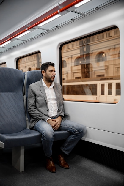 Uomo seduto nel vagone del treno