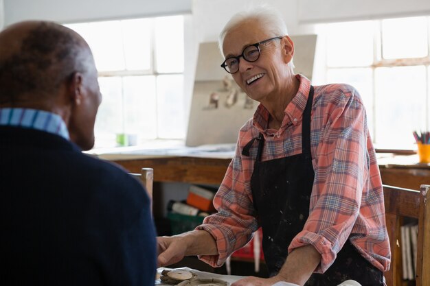 Uomo sorridente che esamina artista maschio