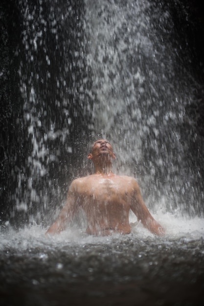 Uomo sotto la cascata