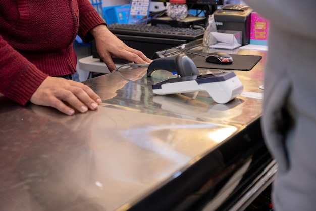 uomo utilizzando una carta bancaria tramite NFC o WIFI o tocca meno per pagare in libreria o negozio di regali.