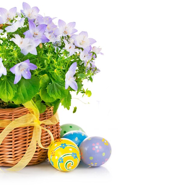 Uova colorate con un cesto di fiori