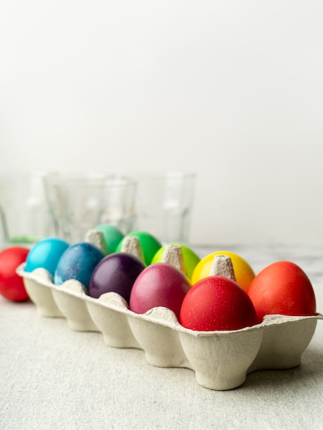 Uova di Pasqua colorate in scatola di cartone sul bancone della cucina