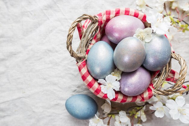 Uova di Pasqua pastello colorate su sfondo tessile con spazio per la vista dall'alto del testo