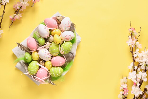 Uova pastello di Pasqua e fiori che sbocciano primaverili