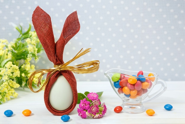 Uovo di festa di Pasqua e dolci su sfondo chiaro