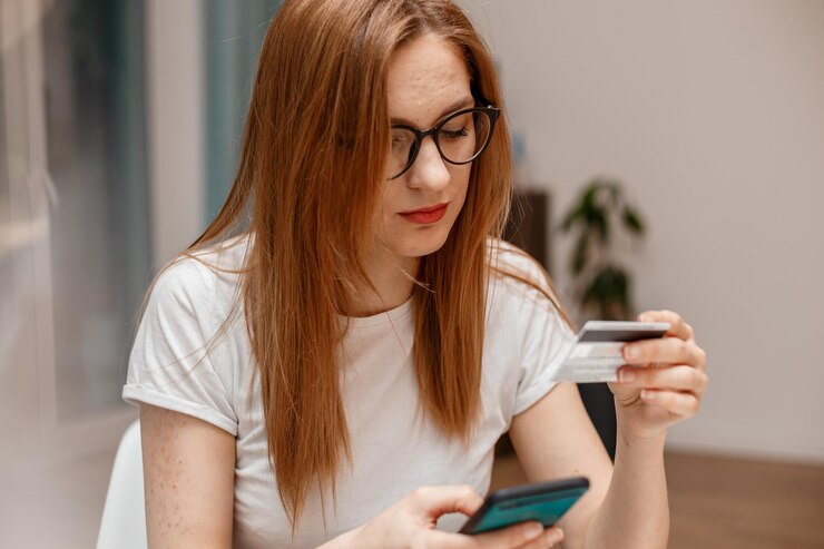 Photo using smartphone and credit card online shopping woman using mobile phone app playing game shopping online ordering delivery relax on sofa a woman shopping online on smartphone with a debit card