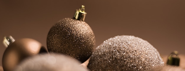 Vacanze di Natale e concetto di decorazione festiva palline dorate su sfondo beige