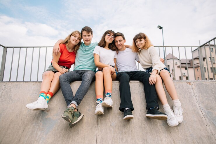 Foto vacanze estive e concetto adolescente - gruppo di adolescenti sorridenti che vanno in giro fuori.
