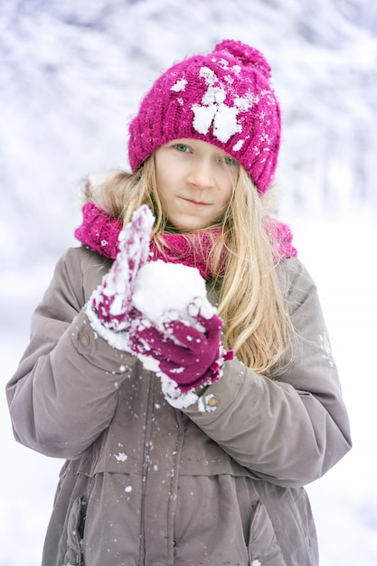 Vacanze invernali - bambina sorridente all'aperto al momento delle nevicate