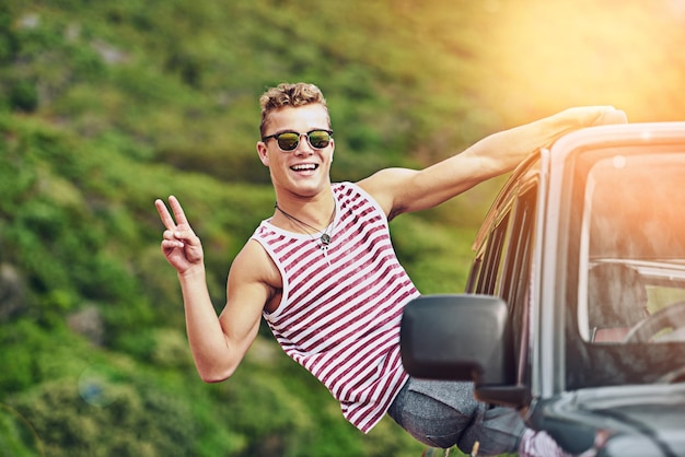 Vacci piano ovunque tu vada Ritratto di un giovane che si sporge dal finestrino di un'auto durante un viaggio