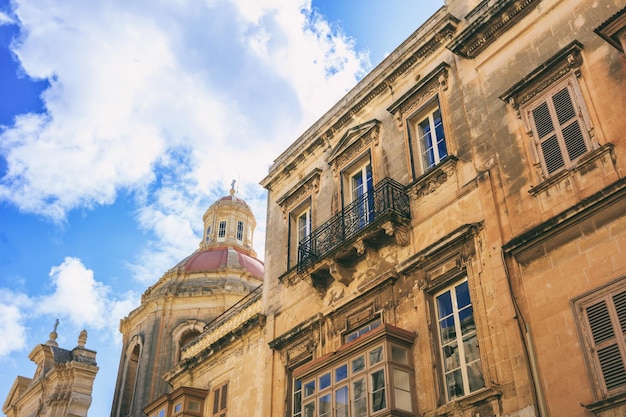Valletta Malta Facciata degli edifici tradizionali e cupola della chiesa sullo sfondo del cielo blu in vista