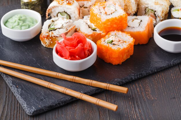 Vari tipi di cibo sushi servito su pietra nera