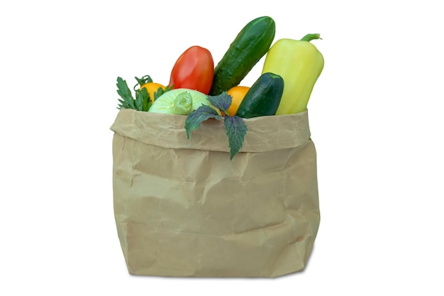 Varie verdure fresche si trovano in un sacchetto kraft isolato su uno sfondo bianco