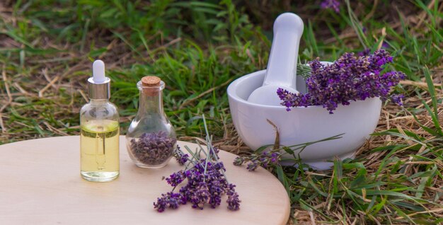 Vasi con olio di lavanda fiori di lavanda sullo sfondo di un campo di lavanda