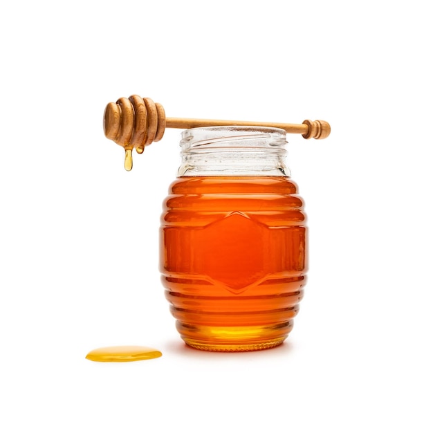 Vaso di vetro pieno di miele mestolo di miele in legno