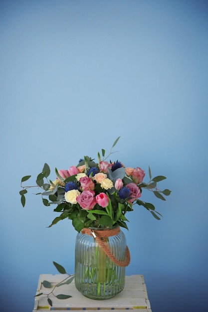 Vaso in vetro con bellissimo bouquet su sfondo colorato