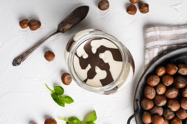 Vaso spalmabile al cioccolato impostato su sfondo bianco tavolo in pietra vista dall'alto piatto