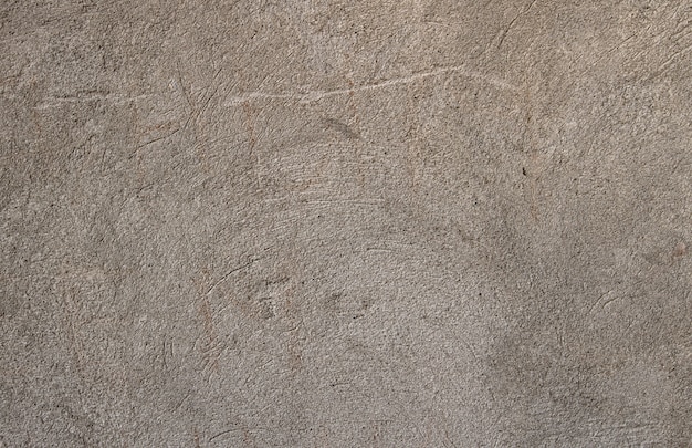 Vecchia decorazione graffiata della parete esterna, colore grigio caldo. struttura