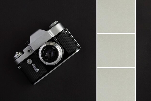 Vecchia fotocamera e quadrati grigi per foto o testo su sfondo nero Vista dall'alto Copia sace