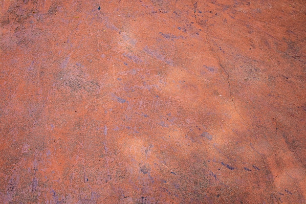 Vecchia parete incrinata o struttura e fondo del pavimento del cemento arancio