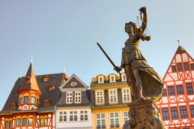 Vecchia piazza Romerberg con la statua di Justitia nella conduttura di Francoforte, Germania con il chiaro cielo