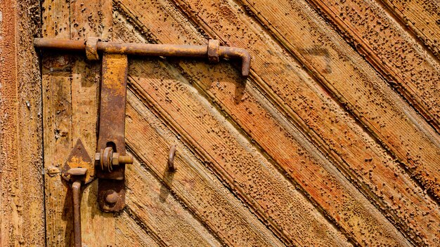 Vecchia porta di legno con una vecchia barra