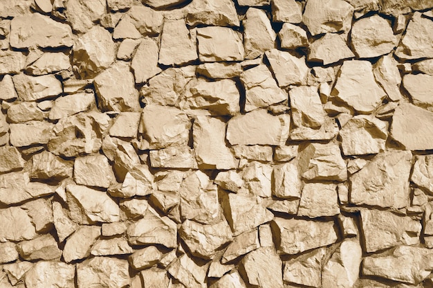 Vecchia struttura beige del fondo della parete di pietra