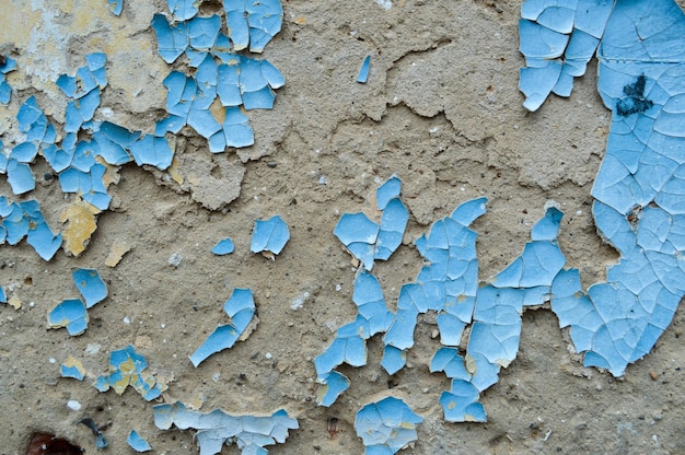 Vecchia vernice scrostata esfoliata blu sul muro di cemento La trama di sfondo