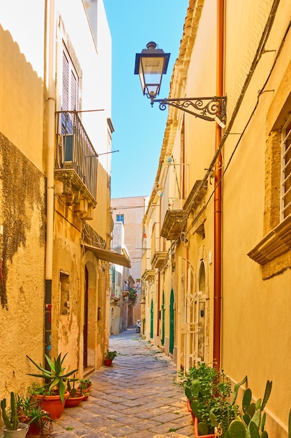 Vecchia via con le case gialle nella vecchia città di Siracusa, Sicilia, Italy