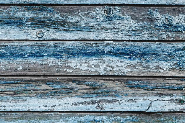 Vecchie plance di legno squallide blu con vernice di colore incrinato