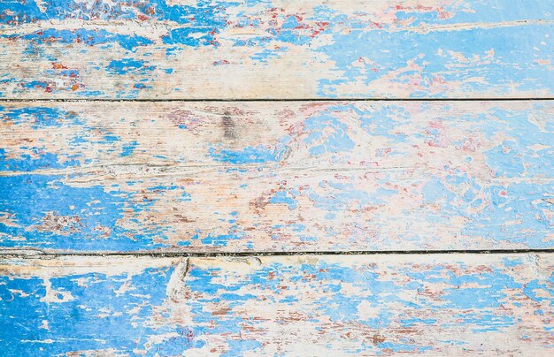 Vecchie plance di legno verniciate blu e beige dell'annata. Trama di sfondo rustico.