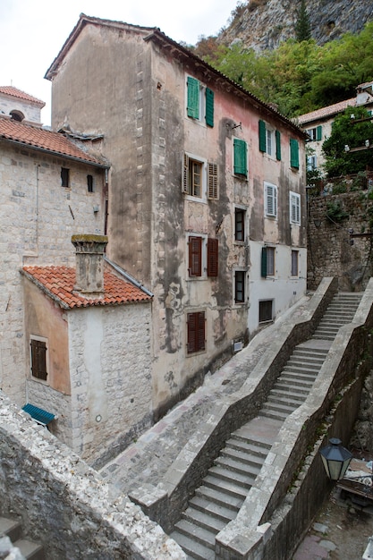 Vecchio edificio in Montenegro con finestre e persiane ed edera