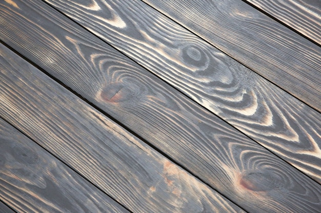 Vecchio fondo di legno dell'annata. Pannelli antichi grigi e marroni. Trama ruvida. Pavimento ispido e granuloso.