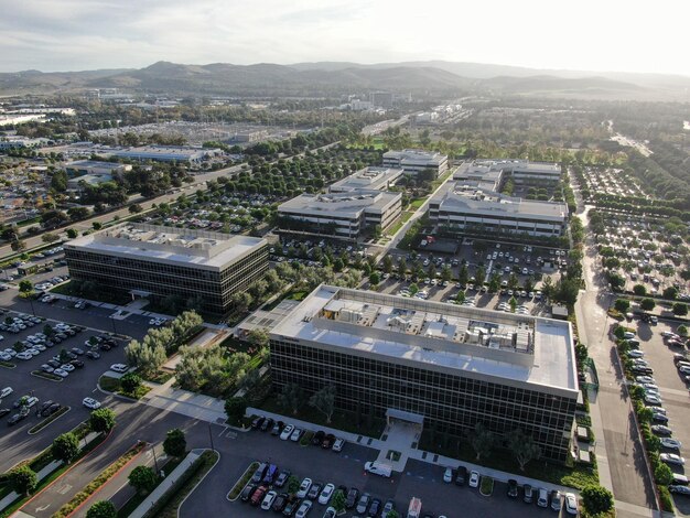 Veduta aerea del quartiere degli affari e della finanza con un nuovo edificio per uffici circondato da parcheggio e strada