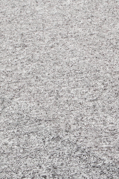 Vero tessuto lavorato a maglia grigio melange fatto di fibre sintetiche con texture di sfondo